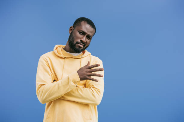 istock skeptical young african american man gesturing by hand isolated on blue background 1043596560