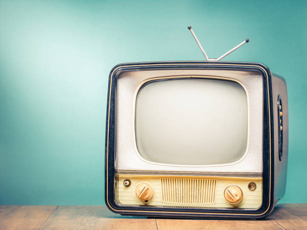 istock Retro old TV set receiver on table front gradient mint green wall background. Broadcasting concept. Vintage style filtered photo 1043598208