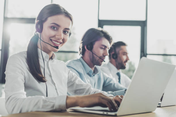 istock happy call center managers working with laptops and microphones at modern office 1043600828