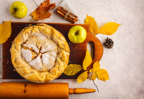 istock Traditional American apple pie on a wooden board, top view. 1043605584