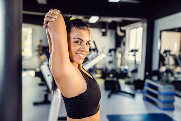 istock Woman doing stretching exercises after a workout at gym 1043608242