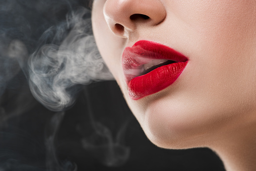 veltalende malm Diligence Cropped View Of Girl With Red Lips Blowing Smoke Isolated On Grey Stock  Photo - Download Image Now - iStock
