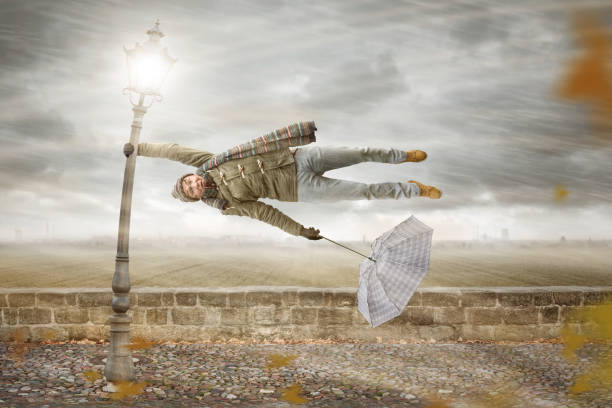istock Man gets blown away by a mighty storm 1043619666