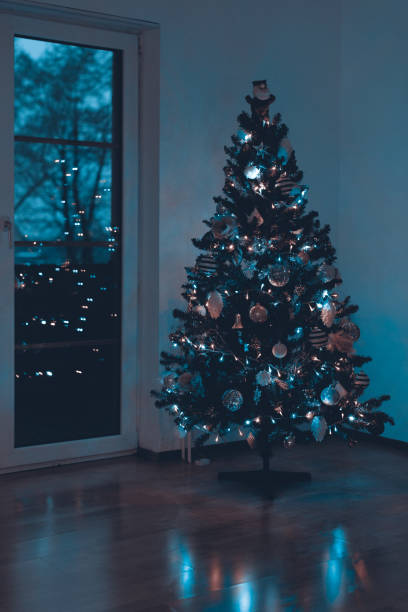 istock Beautiful decorated and illuminated Christmas tree at night. Christmas interior background. 1043623850