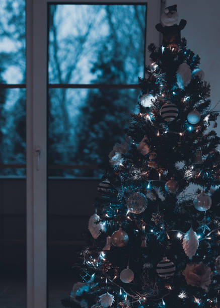 istock Beautiful decorated and illuminated Christmas tree at night. Christmas interior background. 1043624086