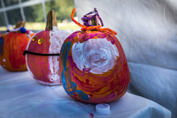 istock Halloween pumpkins painting in the fall 1043627258