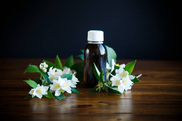 istock Essential aroma oil with jasmine on wooden 1043633254