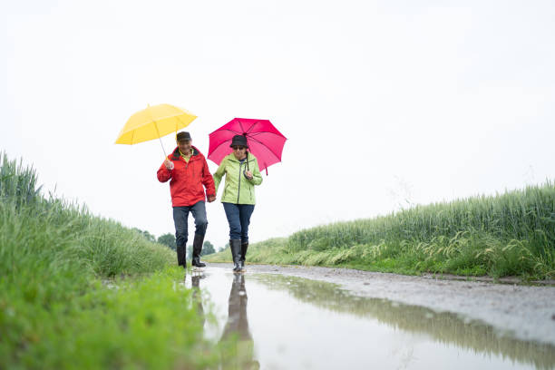 istock senior couple taking a walk on rainy day 1043633870