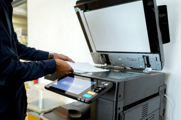 istock Bussiness man Hand press button on panel of printer, printer scanner laser office copy machine supplies start concept. 1043634562