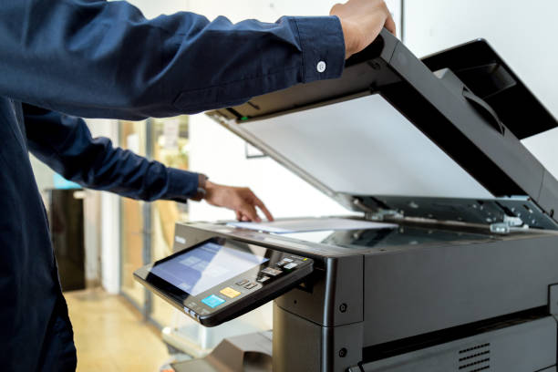 istock Bussiness man Hand press button on panel of printer, printer scanner laser office copy machine supplies start concept. 1043638466