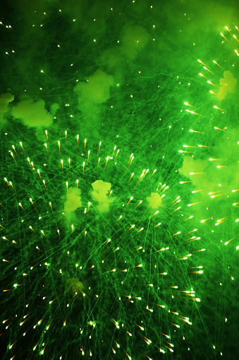 Green fireworks light up the sky - copy space