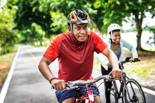 istock Cyclist couple riding together in a park 1043644394