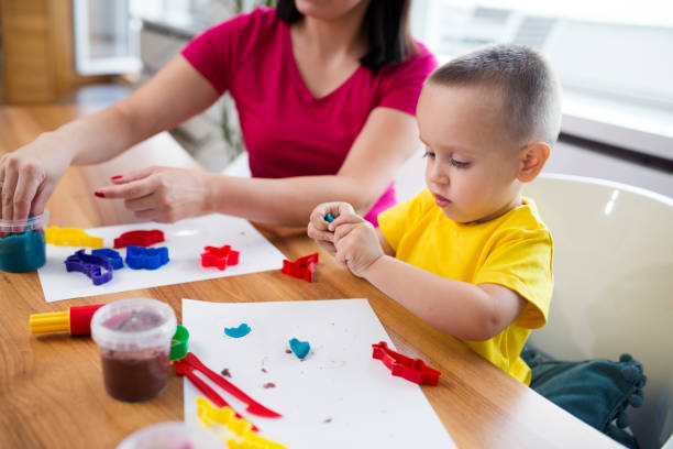 istock Mom and son with clay dough 1043647094