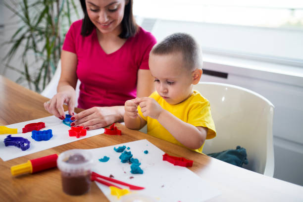 istock Mom and son with clay dough 1043647600
