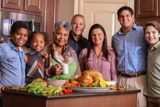 istock Diverse family in home kitchen cooking Thanksgiving dinner. 1043648710