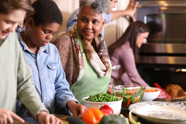 istock Diverse family in home kitchen cooking Thanksgiving dinner. 1043648740