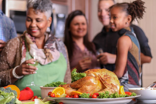 istock Diverse family in home kitchen cooking Thanksgiving dinner. 1043648754