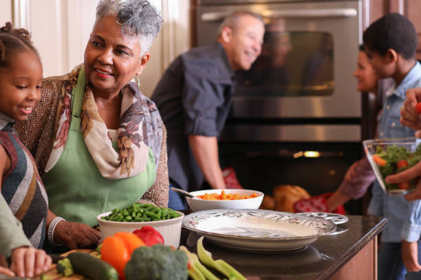 istock Diverse family in home kitchen cooking Thanksgiving dinner. 1043648814