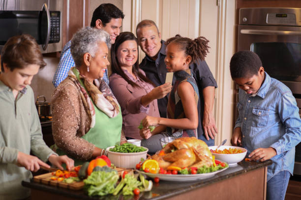 istock Diverse family in home kitchen cooking Thanksgiving dinner. 1043648878
