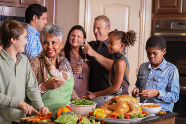 istock Diverse family in home kitchen cooking Thanksgiving dinner. 1043648890