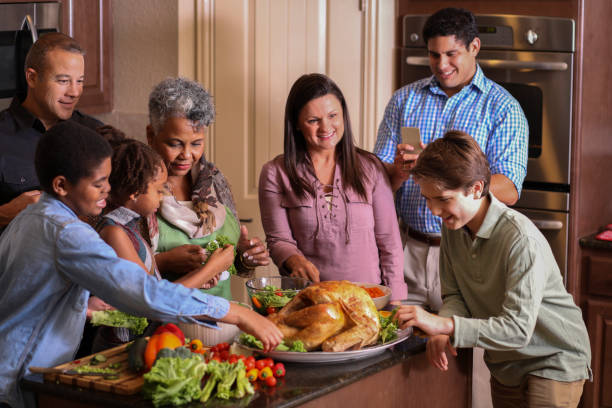 istock Diverse family in home kitchen cooking Thanksgiving dinner. 1043648924