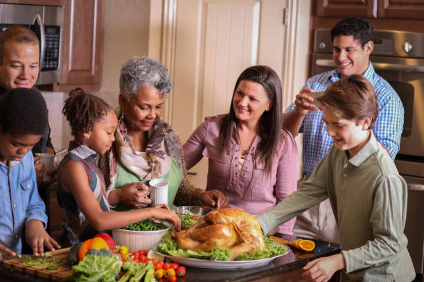 istock Diverse family in home kitchen cooking Thanksgiving dinner. 1043648942