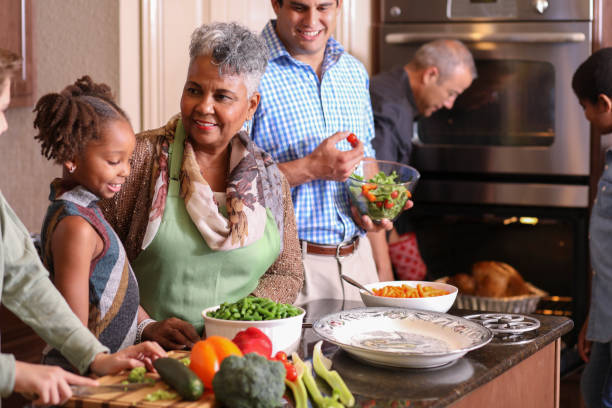 istock Diverse family in home kitchen cooking Thanksgiving dinner. 1043648960
