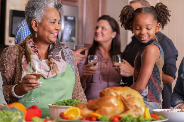 istock Diverse family in home kitchen cooking Thanksgiving dinner. 1043648972