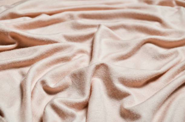 istock Background of a pastel pink silk material close-up. 1043650766