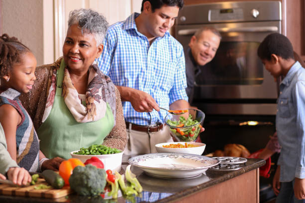 istock Diverse family in home kitchen cooking Thanksgiving dinner. 1043650904