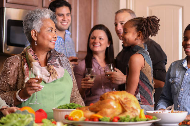 istock Diverse family in home kitchen cooking Thanksgiving dinner. 1043651096