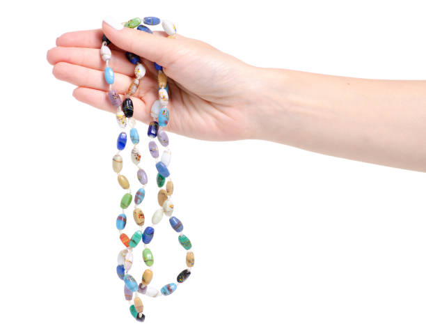 istock Beads colorful stones in hand 1043651260