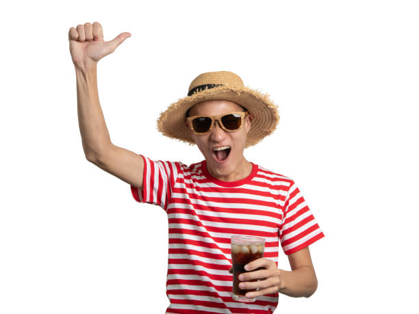 istock Young man holding soft drink shows hand hello greeting. 1043651534