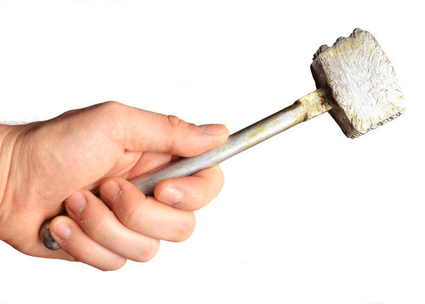 istock Metal kitchen hammer in hand isolated on white background. 1043651674