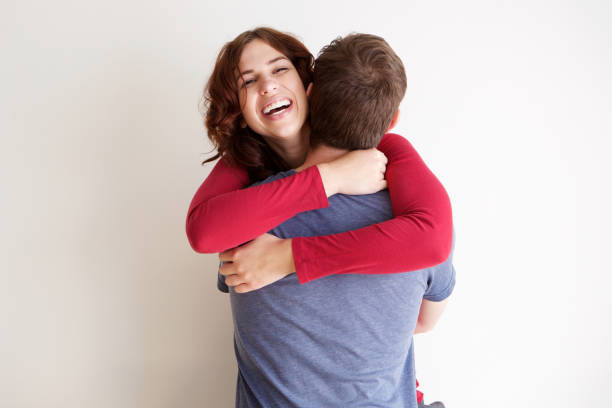 boyfriend and girlfriend hugging each other against white background