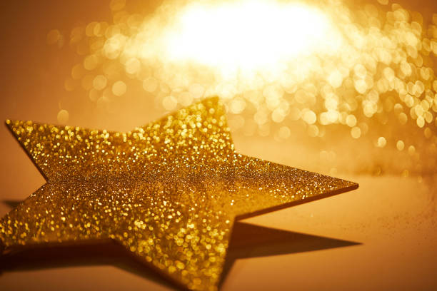 istock golden shiny star for christmas decoration on tabletop 1043656736