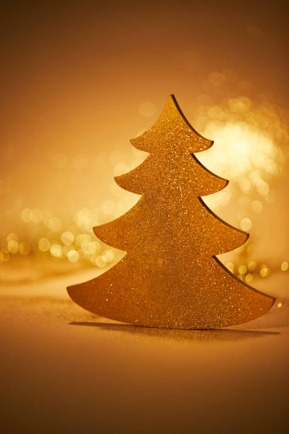 istock golden glittering christmas tree for decoration on tabletop 1043656964