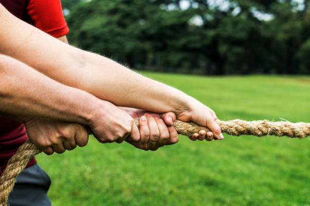 istock Team competing in tug of war 1043657478