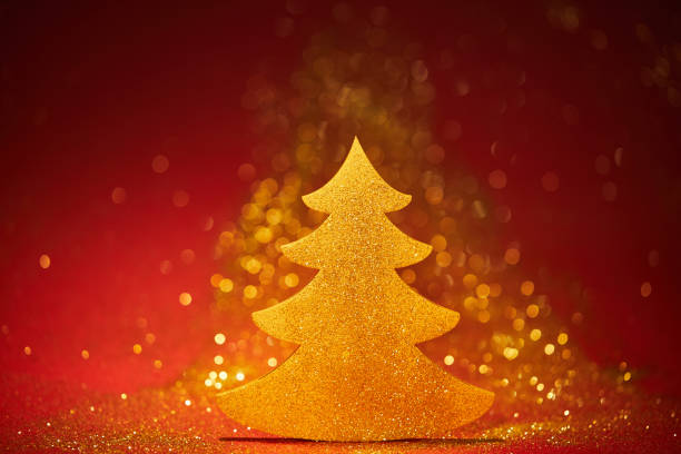 istock golden sparkling christmas tree for decoration on red background 1043657708