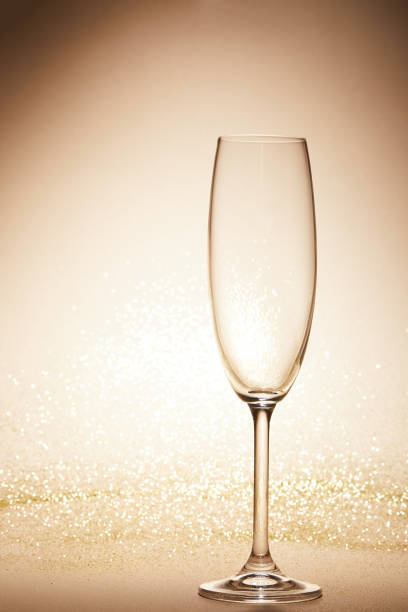 istock empty wineglass with glitter on tabletop, christmas concept 1043657726