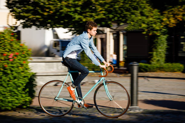 istock Young man biking in city park 1043657888