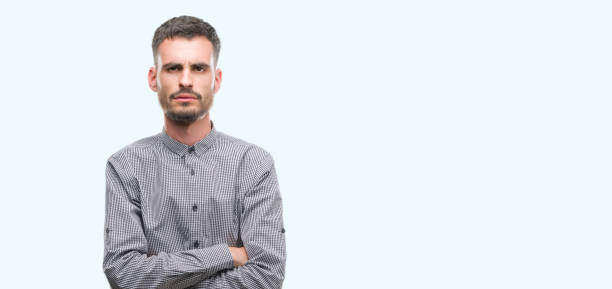 istock Young hipster man skeptic and nervous, disapproving expression on face with crossed arms. Negative person. 1043658568