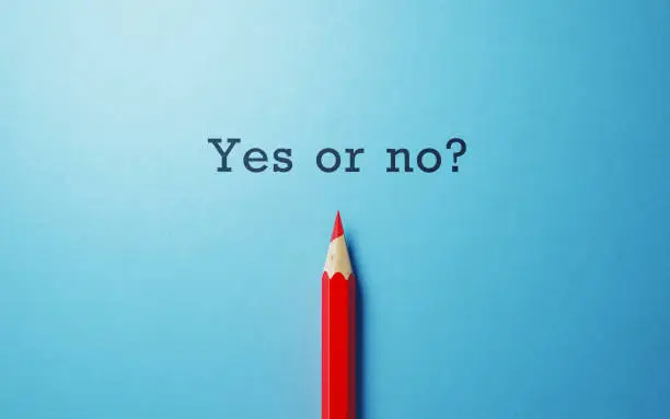 Red pencil and yes or no question on blue background. Horizontal composition with copy space. Questionnaire and dilemma concept.