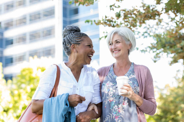 istock Senior woman laughs with friend 1043661896