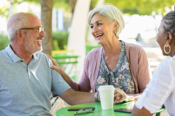 istock Senior adults enjoy visiting in public park 1043661900