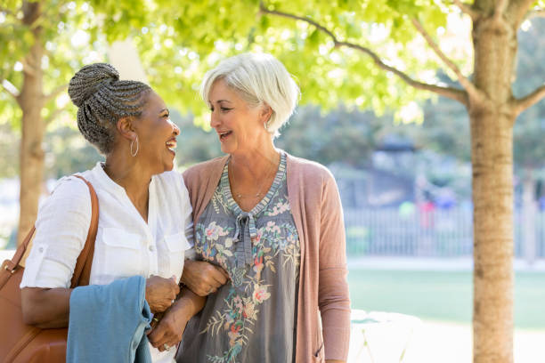istock Senior friends strolling in city park 1043661934