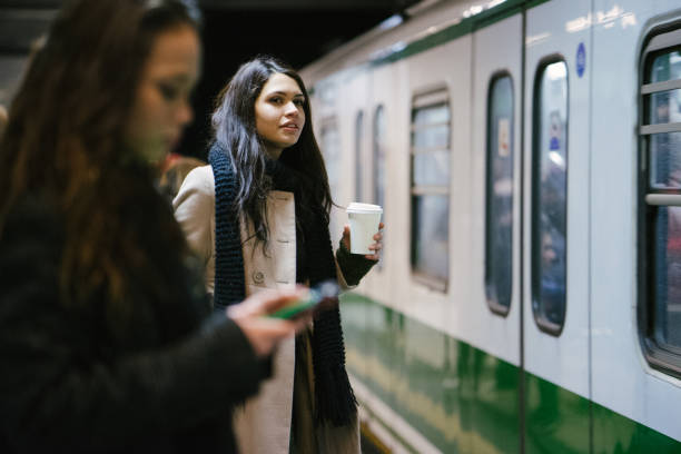 young businesswomen using public transport - travel passenger milan italy italy imagens e fotografias de stock