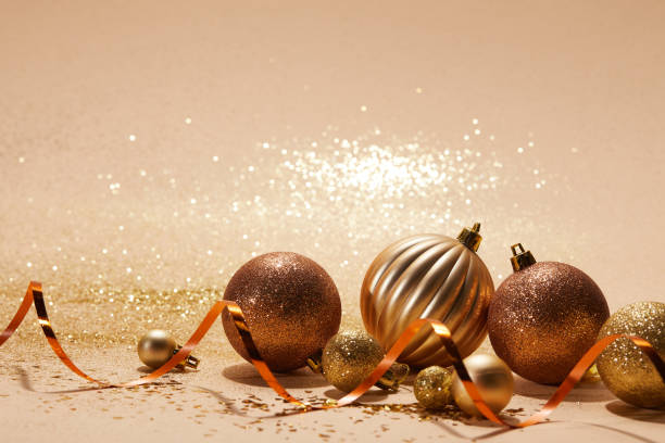 istock glittering bright christmas balls and wavy ribbon on beige tabletop 1043663214
