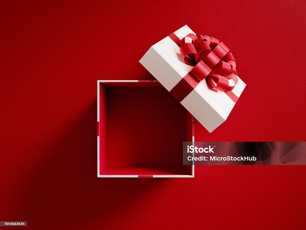 Aprire la confezione regalo bianca legata con nastro rosso - Foto stock royalty-free di Regalo