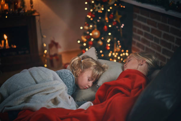 Sleeping on a Couch in a Cosy Christmas Atmosphere Sleeping on a Couch in a Cosy Christmas Atmosphere heat home interior comfortable human foot stock pictures, royalty-free photos & images